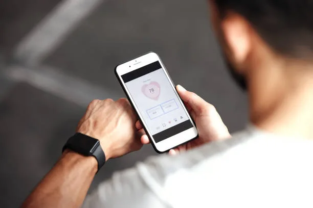 Male athlete tracking heart health blood work results on a mobile device