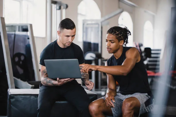 Male athlete following a tailored fat loss program with a trainer