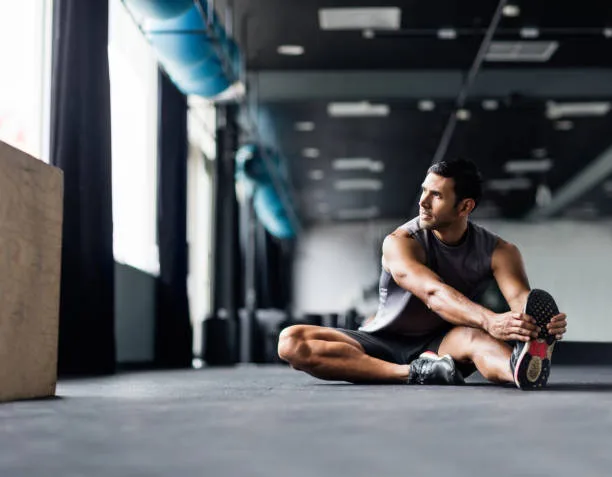 Athlete resting and stretching after excessive cardio training
