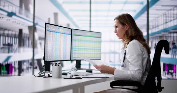 Focused healthcare provider reviewing patient charts with colorful graphs on insulin levels